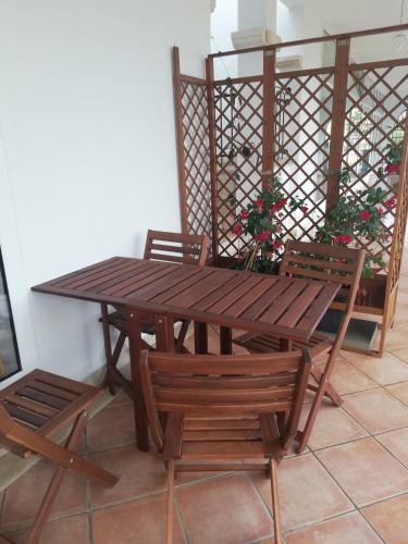 a wooden table and some chairs and a table and a table at Studio apartment Gray in Šibenik