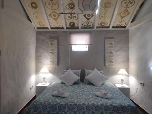 a bedroom with a bed with two slippers on it at Finca Lomo Grande in Hermigua