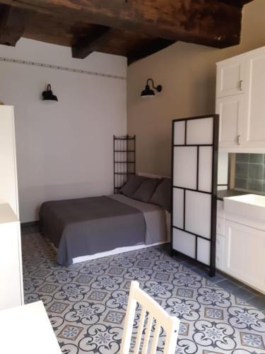 a bedroom with a bed and a chair in it at DomasHome in Domaso