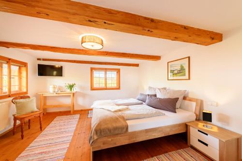 a bedroom with a bed in a room with wooden ceilings at Landsitz Rocky Docky in Niedersonthofen