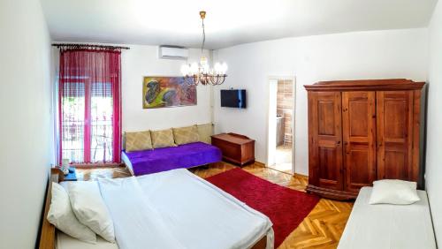 a living room with a bed and a couch at Vila Katarina in Vrnjačka Banja