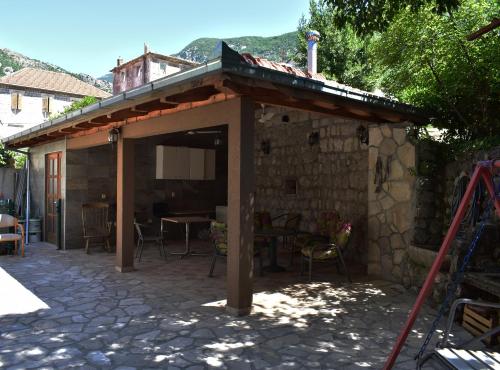 a pavilion with a roof on top of a patio at Apartments Montenegro Risan Čučković in Risan