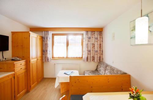 a living room with a couch and a table at Gasthof Gröbenhof in Fulpmes
