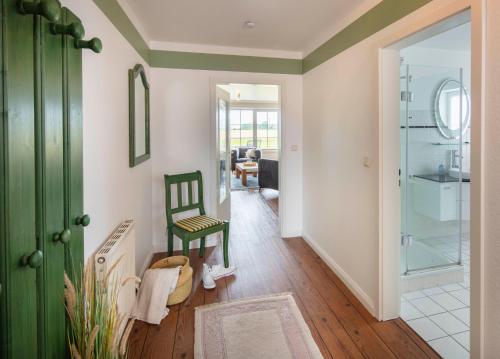 a room with a green door and a green chair at NTBM36001-Binnenseeblick in Neue Tiefe Fehmarn