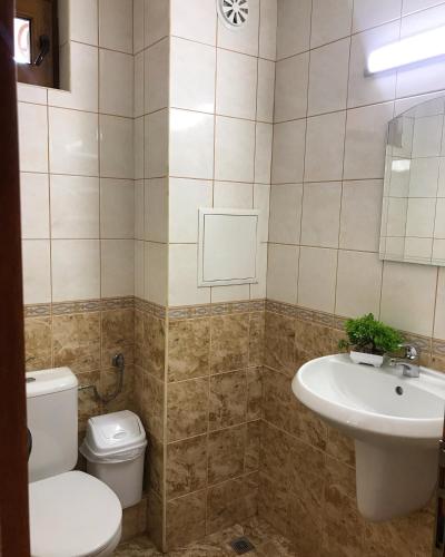 a bathroom with a toilet and a sink at Guest House Val and Kate in Sveti Vlas
