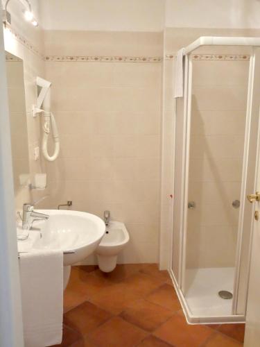 a white bathroom with a sink and a shower at Agriturismo Casa di Campagna in Riva del Garda