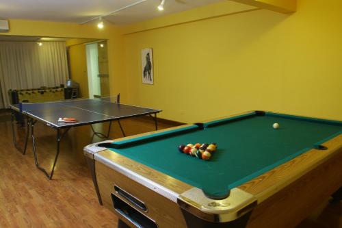 a room with a pool table and a ping pong ball at Salto Grande Hotel in Punta del Este