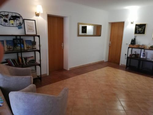 a living room with white walls and a tile floor at Riviera Rooms and Apartments in Rab