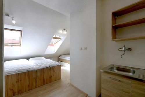 a small bedroom with a bed and a sink at ubytovanie-stiavnica in Banská Štiavnica