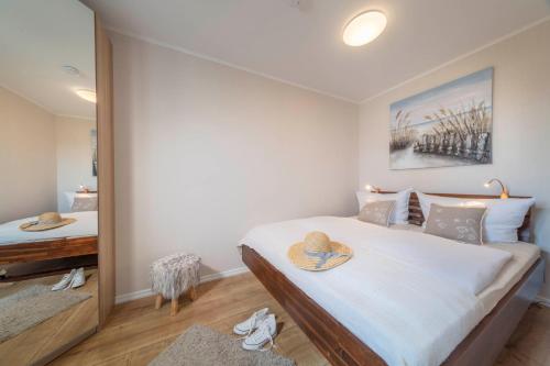 a bedroom with a large bed and a mirror at Strandkorb in Fehmarn