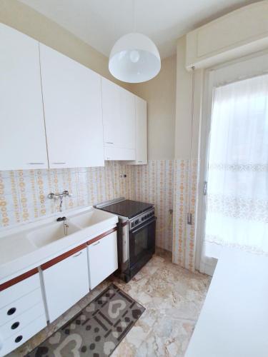 a kitchen with a sink and a stove at Affittacamere Zona Caserma-Stazione in Foligno