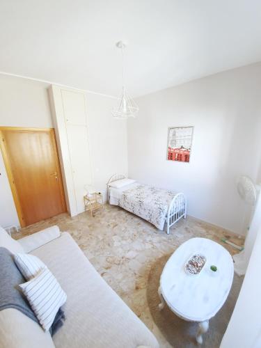 a living room with a couch and a table at Affittacamere Zona Caserma-Stazione in Foligno