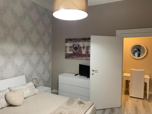 a small bedroom with a bed and a television at Appartamento il Tiglio vicino ospedale in Negrar