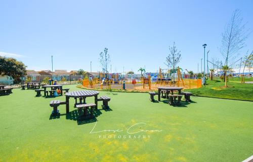 a park with picnic tables and a playground at Big Skies Platinum Plus Holiday Home with Wifi, Netflix, Dishwasher, Decking in Camber