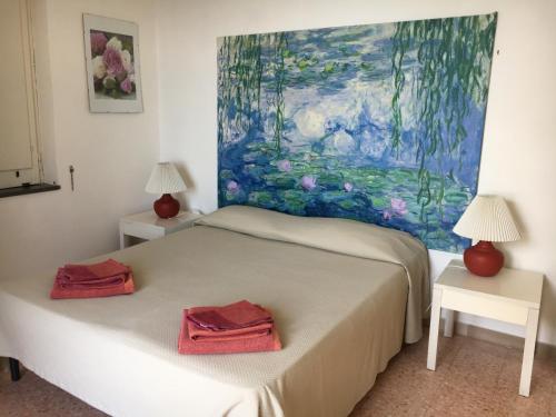 a bedroom with a bed with two red towels on it at Villa Mira Capri in Procida