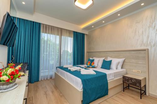 a hotel room with a bed and a window at Luxury Apartments Queen in Petrovac na Moru