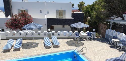 a pool with blue and white chairs and tables and umbrellas at Atlas Pension in Karterados