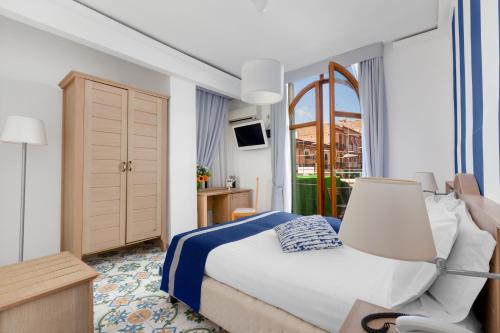 Pokój hotelowy z łóżkiem i krzesłem w obiekcie Hotel Herculaneum w mieście Ercolano