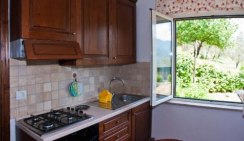 a kitchen with a sink and a stove and a window at Agriturismo Il Casaletto in Montefranco