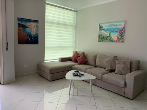 a living room with a couch and a table at Pearl Seaview Apartment in Vlorë