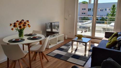 a living room with a table and a couch at APARTAMENT WILKASY II (k. Giżycka ) in Wilkasy