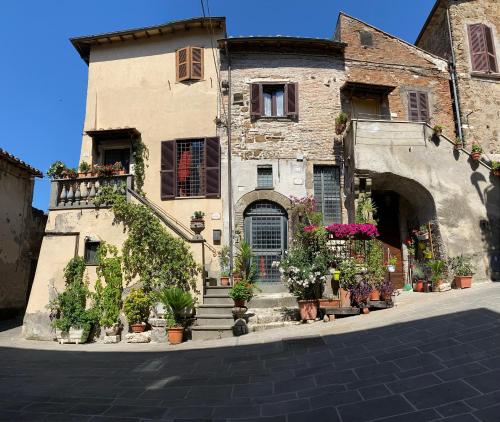 an old building with potted plants on a street at La Torretta in Orte