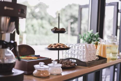 a table with three plates of food on a counter at TOP Garden Aparthotel in Toruń