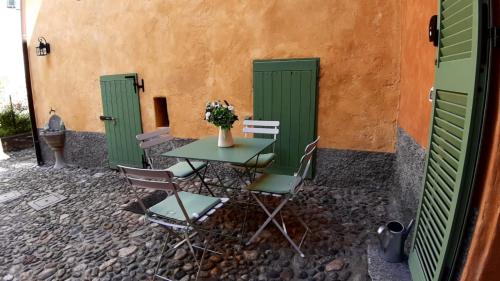 a table and chairs in front of a building at DomasHome in Domaso