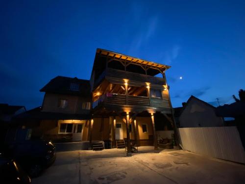 a large building with lights on it at night at River Star in Sîngeorgiu de Pădure