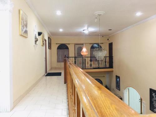 a long hallway with a wooden rail in a building at Senthil Complex in Jaffna