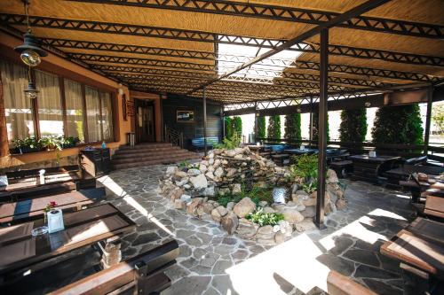 a patio with benches and a fire pit in a building at Sonyachniy Promin in Polyana