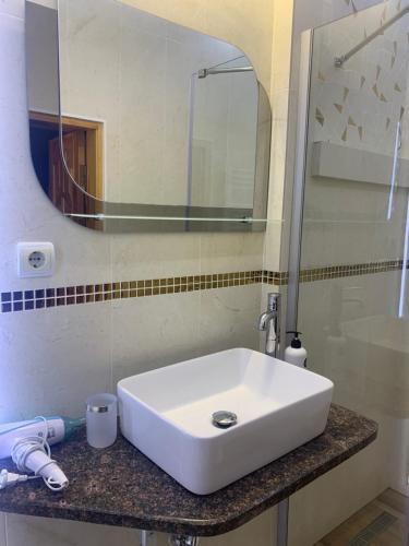 a white sink in a bathroom with a mirror at Будинок Художника in Synevyrsʼka Polyana