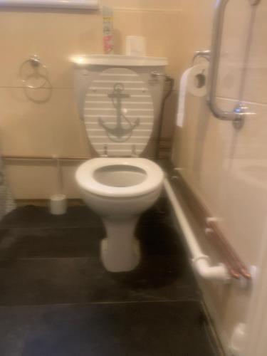 a bathroom with a toilet with an anchor on it at Debbie’s Digs in Ashford