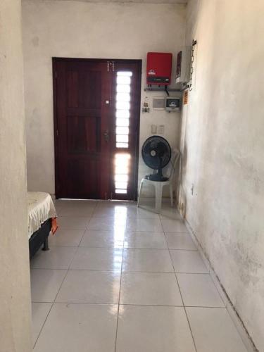 a room with a door and a tiled floor at Praia da Baleia Itapipoca CE in Franco