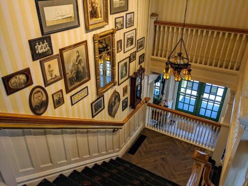 a hallway with a bunch of pictures on the wall at Murray Hotel in Mackinac Island