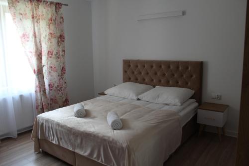 a bedroom with a bed with two pillows on it at Dom w Milówce - Apartamenty na Kowolu in Milówka