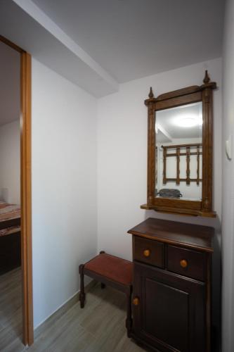 a mirror on top of a dresser in a room at Daglezja in Duszniki Zdrój