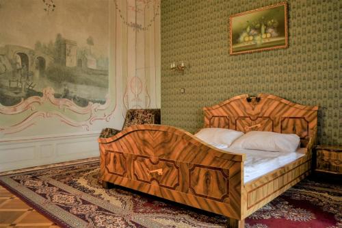 um quarto com uma cama de madeira num quarto em Zámek Lnáře em Lnáře