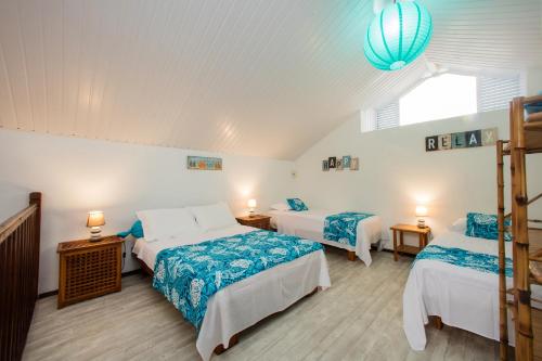 a bedroom with two beds and a window at Villa Tepoe Pool and Beach in Moorea
