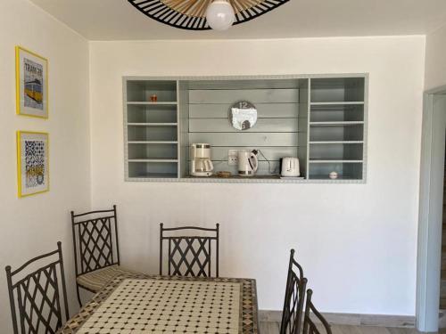 a dining room with a table and two chairs at CASA FANFAMARE in Sesimbra