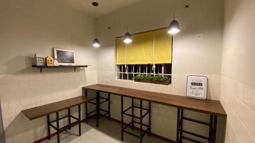 a bar with two wooden stools in a room at Solar 197 Pousada in Timbó