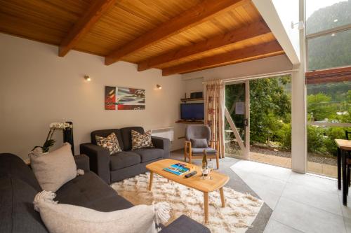 a living room with a couch and a table at Cranbury Court Apartments in Queenstown