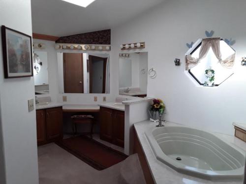 a bathroom with a large tub and a sink at Serenity House Rental in Robertson