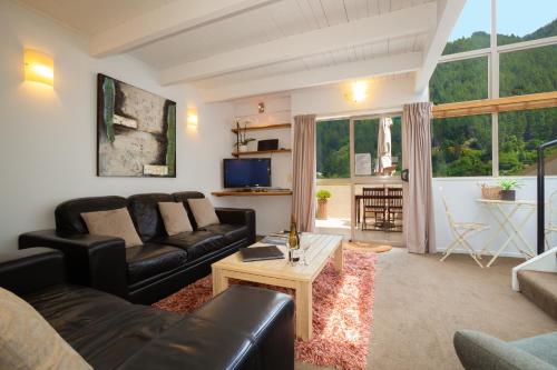 a living room with a couch and a table at Cranbury Court Apartments in Queenstown