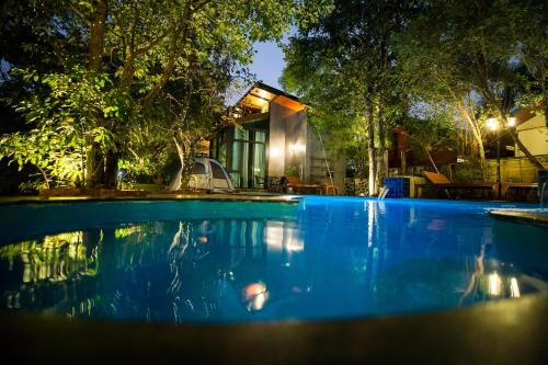 a swimming pool in front of a house at Foresto Sukhothai Guesthome in Sukhothai