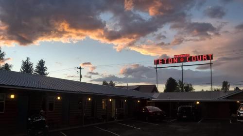 a building with a sign in front of a restaurant at Teton Court Motel in Pinedale