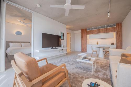 a living room with a bed and a couch and a table at Hotel Ravesis in Sydney