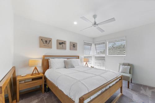 a bedroom with a bed and a ceiling fan at Secret at Huskisson in Huskisson