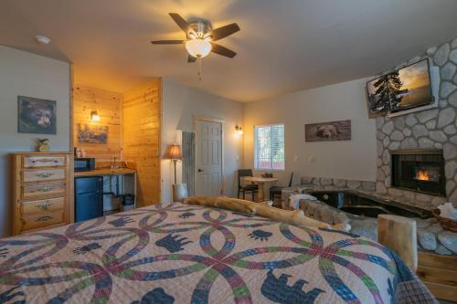 a bedroom with a bed and a fireplace at Black Forest Lodge in Big Bear Lake