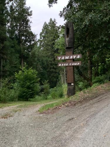 a sign on the side of a dirt road at YAMAYA BASE 1 in Ōkawamochi